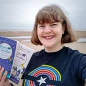 Susan pictured on Blackpool beach with her three books
