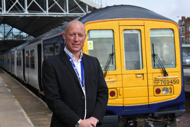 Northern Regional Director Chris Jackson stand with one of Northern's bi-mode 769 trains