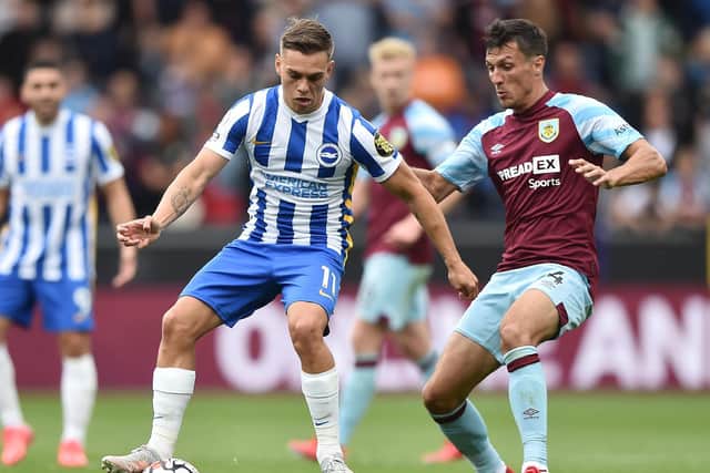 Leandro Trossard of Brighton and Hove Albion is closed down by Jack Cork of Burnley during the Premier League match between Burnley and Brighton & Hove Albion at Turf Moor on August 14, 2021 in Burnley, England.