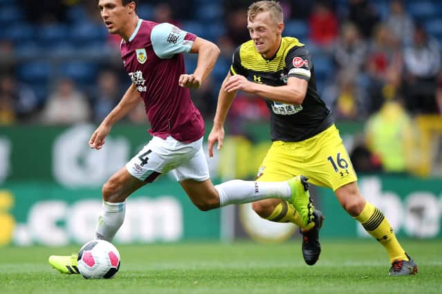 Jack Cork of Burnley runs with the ball under pressure from James Ward-Prowse of Southampton during the Premier League match between Burnley FC and Southampton FC at Turf Moor on August 10, 2019 in Burnley, United Kingdom.