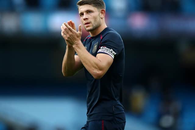 James Tarkowski of Burnley acknowledges the fans after his sides defeat in the Premier League match between Manchester City and Burnley at Etihad Stadium on October 16, 2021 in Manchester, England.