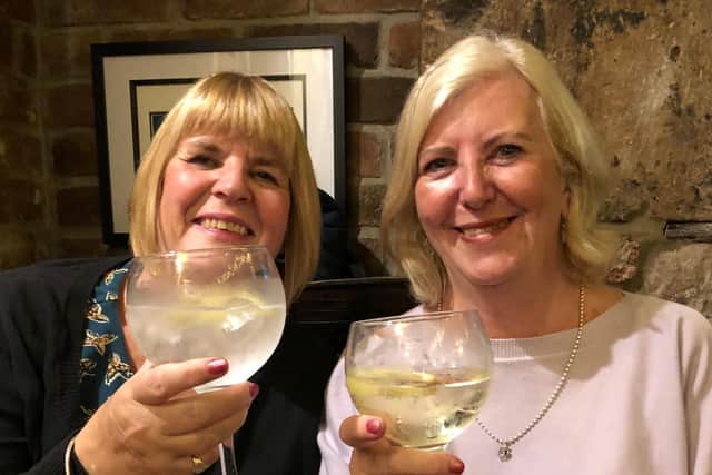 Cheers! Sisters Freda (left) and Susan celebrate their success at walking 100 miles in a month