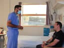 ELHT operating surgeon Mr Choudry meets with Andrew Cook.