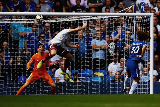 Sam Vokes of Burnley scores his sides third goal past Thibaut Courtois of Chelsea during the Premier League match between Chelsea and Burnley at Stamford Bridge on August 12, 2017 in London, England.