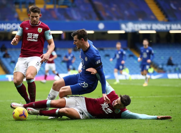 Burnley's English defender Matthew Lowton (R) vies with Chelsea's English midfielder Mason Mount during the English Premier League football match between Chelsea and Burnley at Stamford Bridge in London on January 31, 2021.