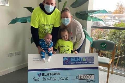 The Johnson family present the cheque for £2,000 to NICU, money they raised to thank the team for caring for baby Jasper.