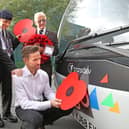 The Burnley Bus Company’s buses are being adorned with poppies to support the annual Poppy Appeal, as the nation prepares to remember the fallen. From left, veterans Geoff Lister, Michael Scott and Keith Webster watch as engineer Jonathan Ruston fits a poppy to one of the company’s buses.
