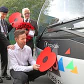 The Burnley Bus Company’s buses are being adorned with poppies to support the annual Poppy Appeal, as the nation prepares to remember the fallen. From left, veterans Geoff Lister, Michael Scott and Keith Webster watch as engineer Jonathan Ruston fits a poppy to one of the company’s buses.