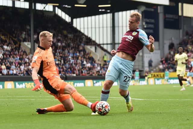 Matej Vydra of Burnley is challenged by Aaron Ramsdale of Arsenal leading to a penalty which is overturned following a VAR review during the Premier League match between Burnley and Arsenal at Turf Moor on September 18, 2021 in Burnley, England.