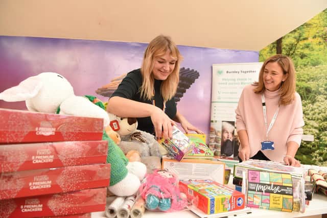 Burnley Together co-ordinator Nicola Larnach (right) andCalico Group employee Lisa Valentine sort through some of the donations already received for the Christmas present appeal.