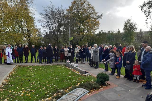 Family and friends of Enzo Manta gather at Turf Moor memorial garden on Sunday.