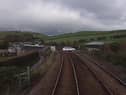 A still image from a Network Rail video showing a driver taking their life in their hands by jumping red lights at a level crossing in Cumbria.