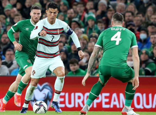 Republic of Ireland's defender Shane Duffy (R) vies with Portugal's striker Cristiano Ronaldo during the FIFA World Cup Qatar 2022 qualifying round Group A football match between Ireland and Portugal at the Aviva Stadium in Dublin on November 11, 2021.