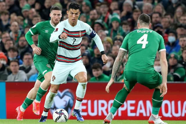 Republic of Ireland's defender Shane Duffy (R) vies with Portugal's striker Cristiano Ronaldo during the FIFA World Cup Qatar 2022 qualifying round Group A football match between Ireland and Portugal at the Aviva Stadium in Dublin on November 11, 2021.