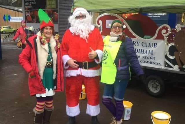 Santa in rehearsal for his visit to Burnley with elf helpers Cathy Watson and Gail Smith