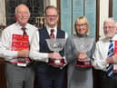 Representatives of the two choirs receive the commemorative bowls