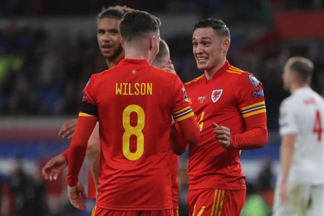 Wales' defender Connor Roberts (R) celebrates with teammates after scoring their fifth goal during the FIFA World Cup 2022 Group E qualifier football match between Wales and Belarus at Cardiff City Stadium in Cardiff, south Wales on November 13, 2021.