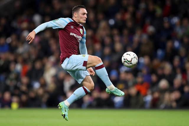 Connor Roberts of Burnley jumps to control the ball during the Carabao Cup Round of 16 match between Burnley and Tottenham Hotspur at Turf Moor on October 27, 2021 in Burnley, England.