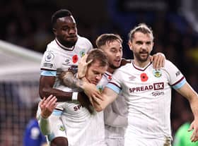 Matej Vydra celebrates with teammates Josh Brownhill and Jay Rodriguez of Burnley after scoring their team's first goal during the Premier League match between Chelsea and Burnley at Stamford Bridge on November 06, 2021 in London, England.