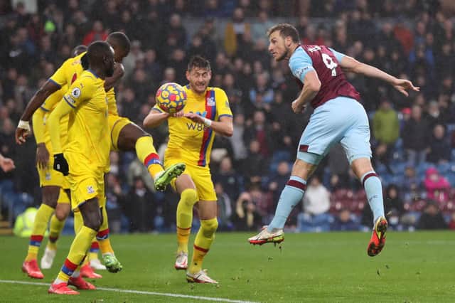Chris Wood of Burnley scores their team's second goal past Joel Ward of Crystal Palace during the Premier League match between Burnley and Crystal Palace at Turf Moor on November 20, 2021 in Burnley, England.