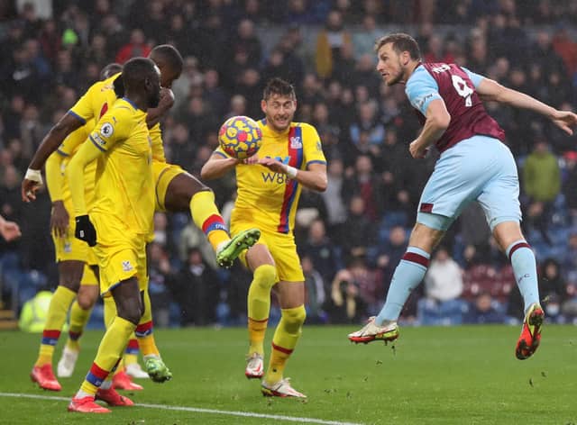 Chris Wood of Burnley scores their team's second goal past Joel Ward of Crystal Palace during the Premier League match between Burnley and Crystal Palace at Turf Moor on November 20, 2021 in Burnley, England.