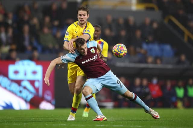 Chris Wood of Burnley is brought down by Joachim Andersen of Crystal Palace during the Premier League match between Burnley and Crystal Palace at Turf Moor on November 20, 2021 in Burnley, England.