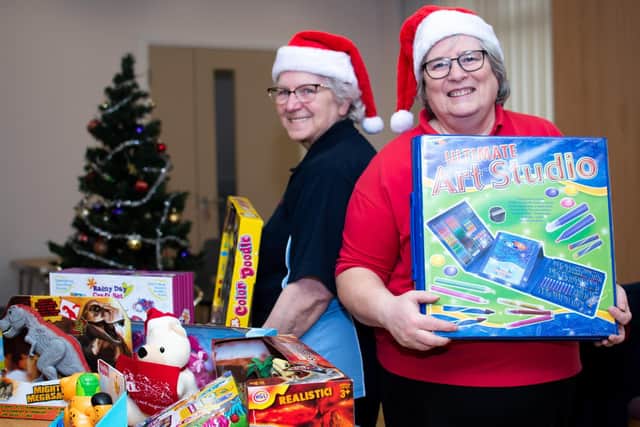 Territorial Envoy Brenda Wise and Capt. Elizabeth Smith call upon the kindness of local people to donate new toys for the needy this Christmas