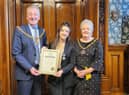Lamissah proudly shows her Medal of Honour she won at the British Citizen Youth Awards to the Mayor and Mayoress of Burnley Coun. Mark Townsend and his wife Kerry