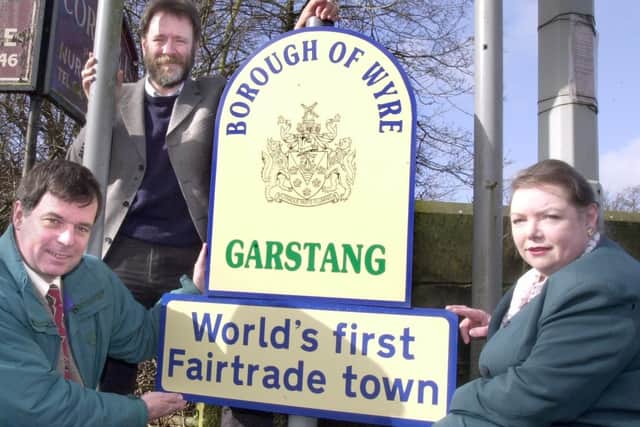 Sign celebrating Garstang as the world's first Fair Trade Town (Bruce Crowther pictured centre)
