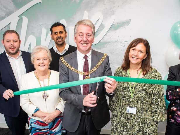 The Mayor of Burnley, Coun. Mark Townsend, with the Mayoress Mrs Kerry Townsend, cutting the ribbon to officially launch Thrive, watched by representatives from Burnley Council, Calico Group, the DWP and the borough's MP Antony Higginbotham.