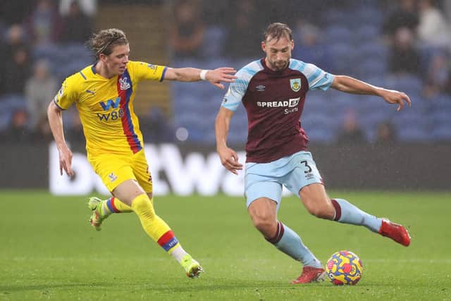 Charlie Taylor of Burnley makes a pass whilst under pressure from Conor Gallagher of Crystal Palace during the Premier League match between Burnley and Crystal Palace at Turf Moor on November 20, 2021 in Burnley, England.