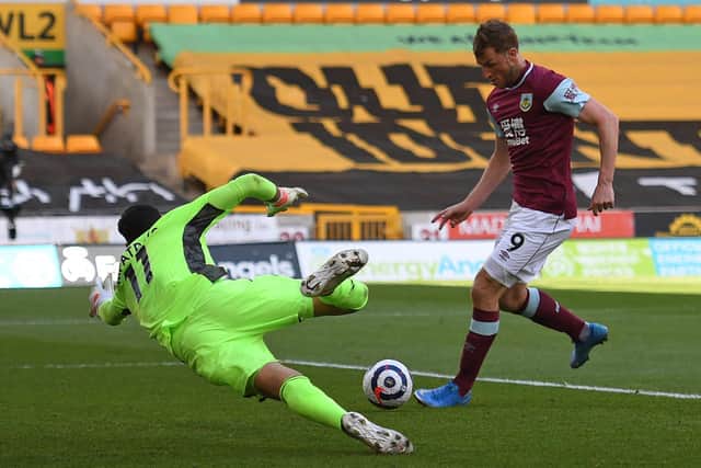 Burnley's New Zealand striker Chris Wood (R) scores his team's second goal past Wolverhampton Wanderers' Portuguese goalkeeper Rui Patricio during the English Premier League football match between Wolverhampton Wanderers and Burnley at the Molineux stadium in Wolverhampton, central England on April 25, 2021.
