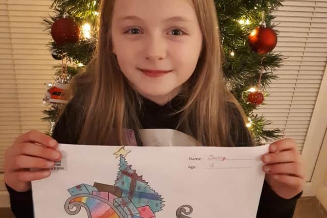 Darcey Blackledge (nine) with her design for Santa's new sleigh