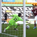 Chris Wood of Burnley scores their team's first goal past Rui Patricio of Wolverhampton Wanderers during the Premier League match between Wolverhampton Wanderers and Burnley at Molineux on April 25, 2021 in Wolverhampton, England.
