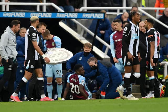 Maxwel Cornet of Burnley down injured during the Premier League match between Newcastle United and Burnley at St. James Park on December 04, 2021 in Newcastle upon Tyne, England.