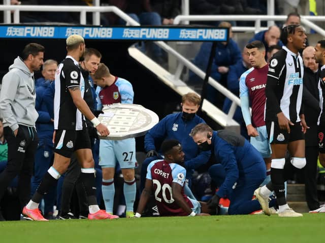 Maxwel Cornet of Burnley down injured during the Premier League match between Newcastle United and Burnley at St. James Park on December 04, 2021 in Newcastle upon Tyne, England.