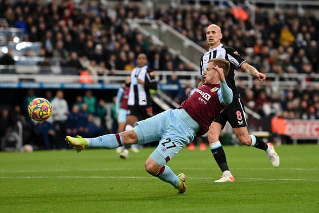 Nick Pope of Burnley is challenged by Fabian Schaer of Newcastle United in the build up to the first Newcastle United goal during the Premier League match between Newcastle United and Burnley at St. James Park on December 04, 2021 in Newcastle upon Tyne, England.