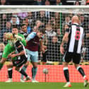 Nick Pope of Burnley is challenged by Fabian Schaer of Newcastle United in the build up to the first Newcastle United goal during the Premier League match between Newcastle United and Burnley at St. James Park on December 04, 2021 in Newcastle upon Tyne, England.