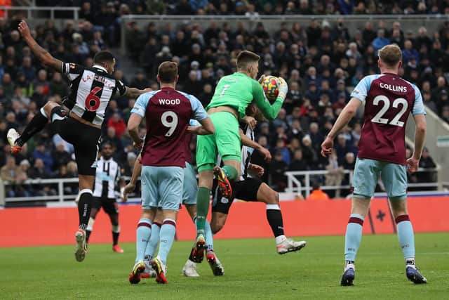 Nick Pope of Burnley comes out to collect a cross and collides with Fabian Schar of Newcastle United and drops the ball, leading to the only goal of the gameduring the Premier League match between Newcastle United and Burnley at St. James Park on December 04, 2021 in Newcastle upon Tyne, England.
