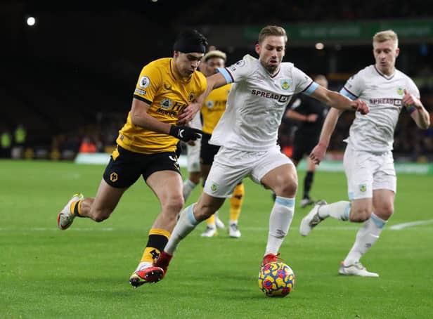 Raul Jimenez of Wolverhampton Wanderers battles for possession with Charlie Taylor of Burnley during the Premier League match between Wolverhampton Wanderers and Burnley at Molineux on December 01, 2021 in Wolverhampton, England.