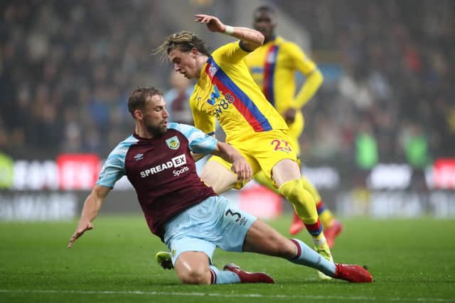 Conor Gallagher of Crystal Palace battles for possession with Charlie Taylor of Burnley during the Premier League match between Burnley and Crystal Palace at Turf Moor on November 20, 2021 in Burnley, England.