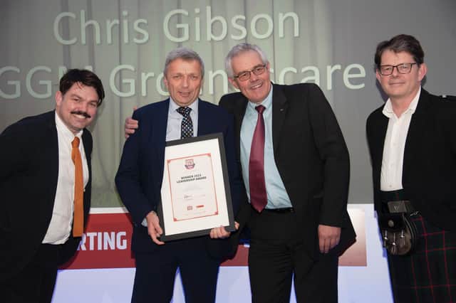 Chris Gibson is presented with his award by David Hart, managing director of award sponsor Kubota UK, with Service Dealer owner Duncan Murray-Clarke, right and comedian Charlie Baker, left.