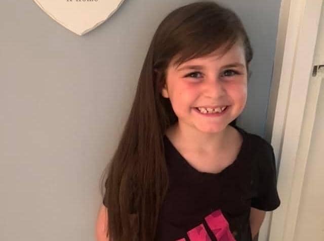 Lola Addis (seven) is raising money for a charity in her great grandad's memory by having her long hair cut