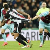Chris Wood of Burnley pulls the shirt of Jamaal Lascelles of Newcastle United during the Premier League match between Newcastle United and Burnley at St. James Park on December 04, 2021 in Newcastle upon Tyne, England.