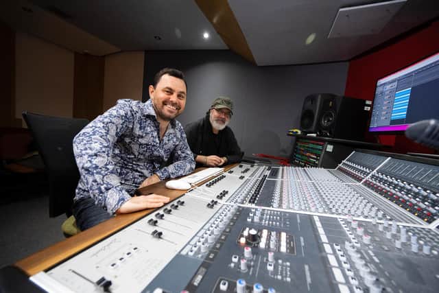 UCLan student Paul Wolski (left) with Anthony King, who worked on the song's orchestral arrangements, piano, keyboards, organs and bass, at a mixing desk in UCLan's Media Factory.