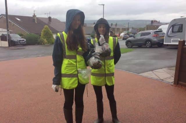 Olivia Dalzel-Job and Honey Edwards collecting bags of rubbish from the streets of Langho