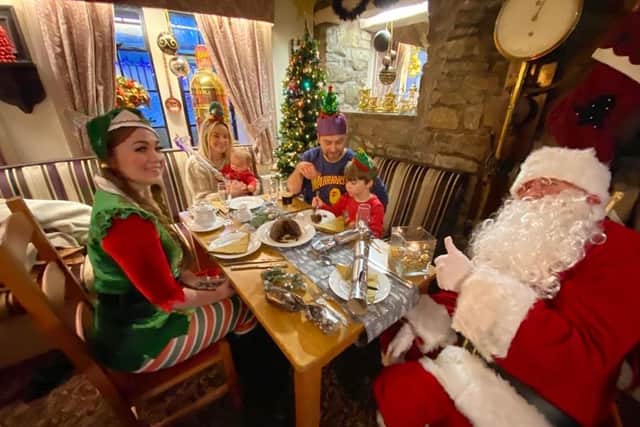 Father Christmas joins elf Rowenna Baldwin and Colne family the Tanseys for a festive meal (photo courtesy of Kev Furber)