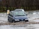 Cars negotiate the flood waters on Eastway, Fulwood, Preston