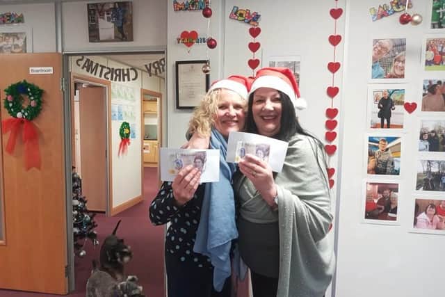 Sharon Lees (right) and her sister Debra Kelly with the cards and £20 cash gift they received from Burnley's 'secret Santa'