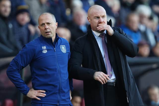 Sean Dyche, Manager of Burnley interacts with Ian Woan, Assistant Manager of Burnley during the Premier League match between Burnley and West Ham United at Turf Moor on December 12, 2021 in Burnley, England.